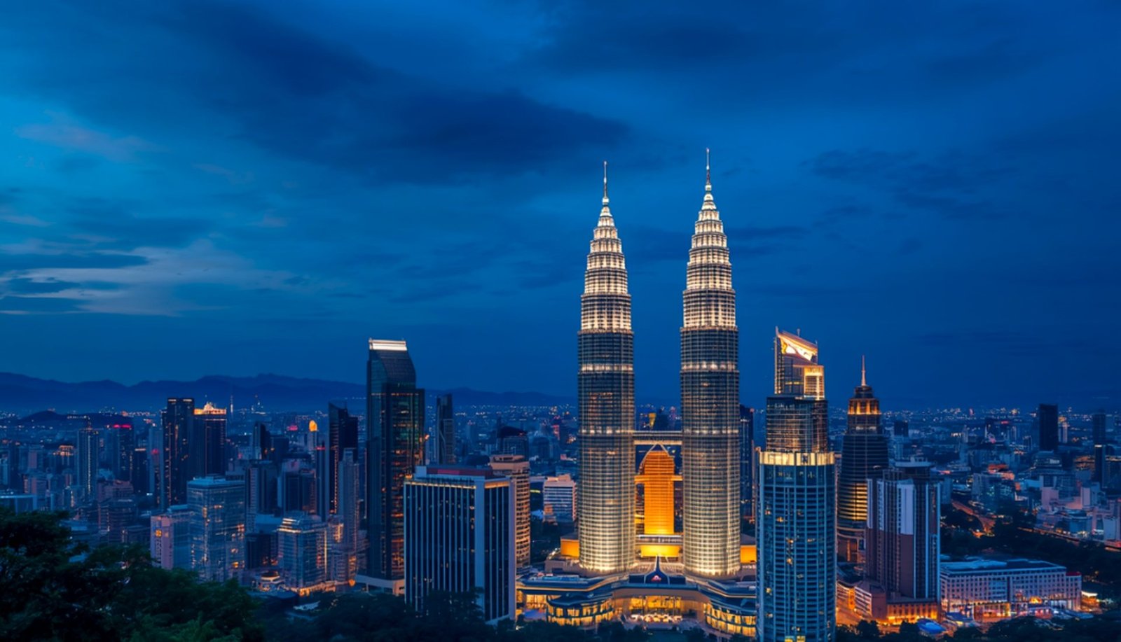 AiSEAN venue exterior at dusk with the Petronas Towers in the background